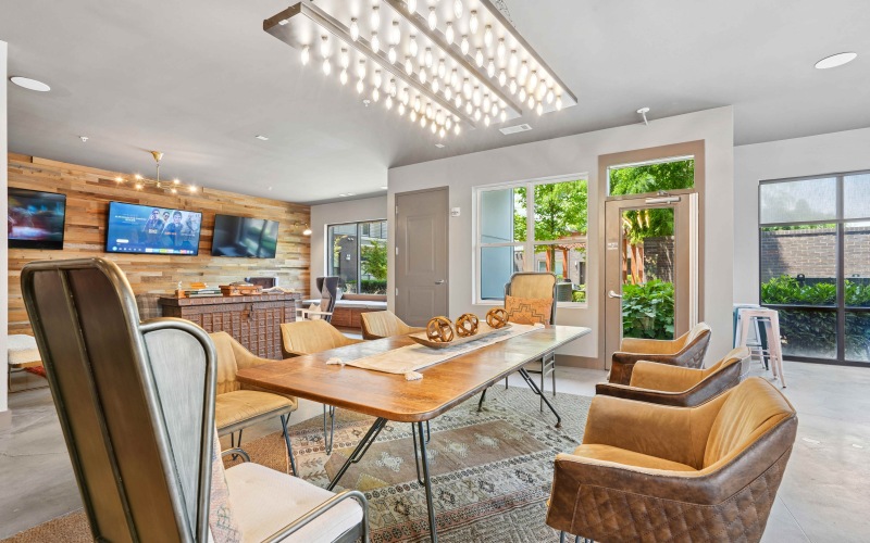 a room with games, tv's, tables and chairs