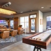 a room with games, tv's, tables and chairs